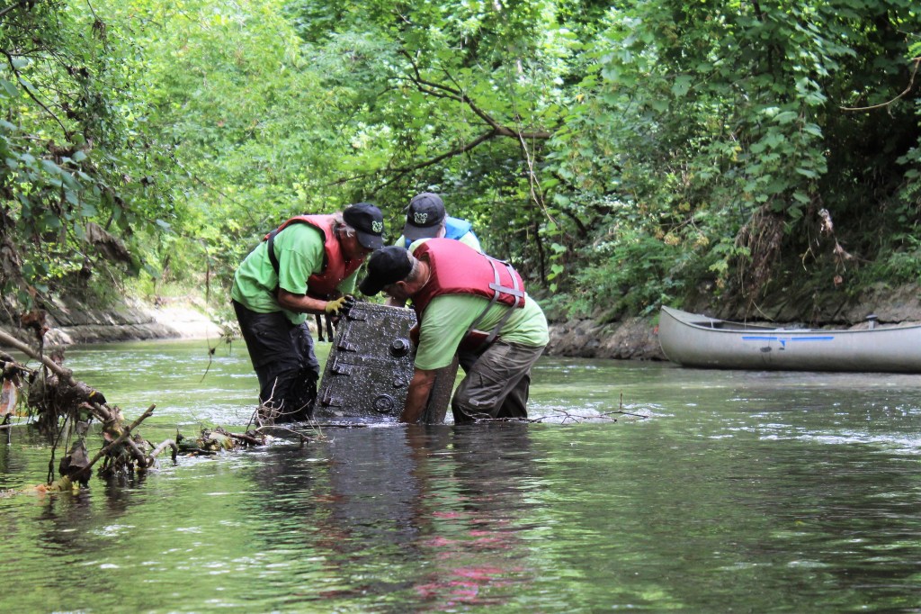 creek rats pulling muddy safe out of Onondaga Creek